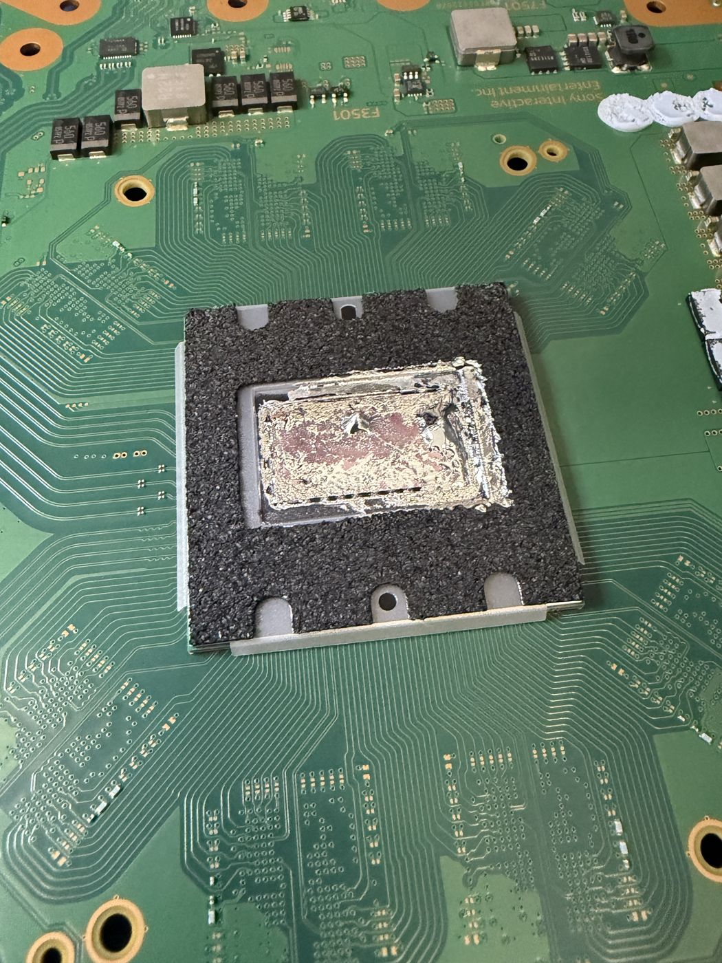 Game console motherboard repair at the 2A Electronics bench in Chicago