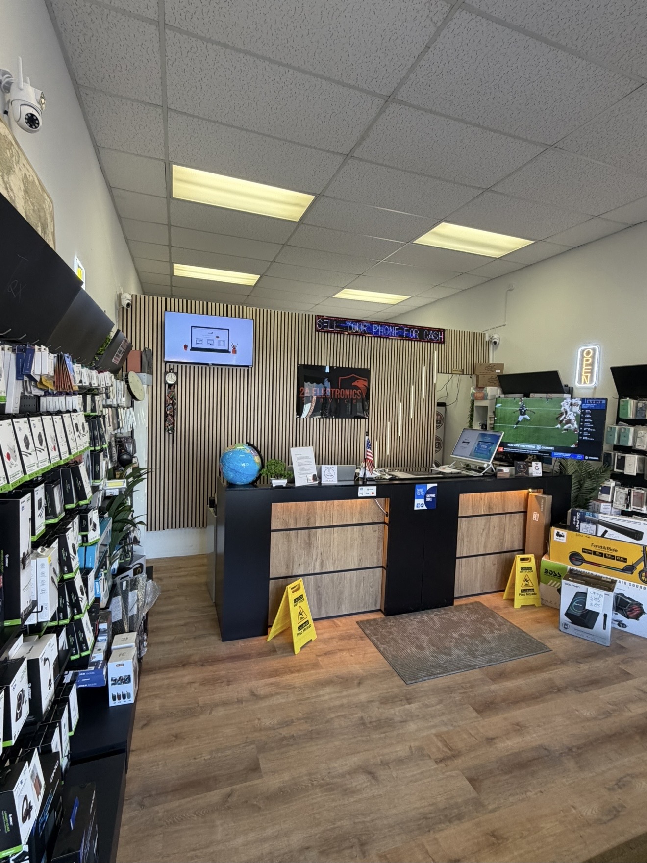 Inside the 2A Electronics store with accessories wall and service counter